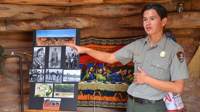 park ranger in uniform pointing to presentation