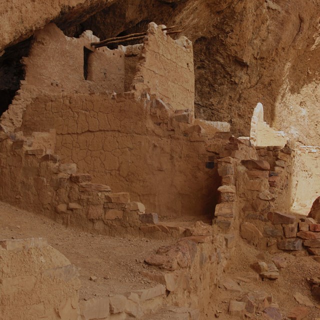 stone staircase at the base of a partially collapsed masonry building constructed under a large over