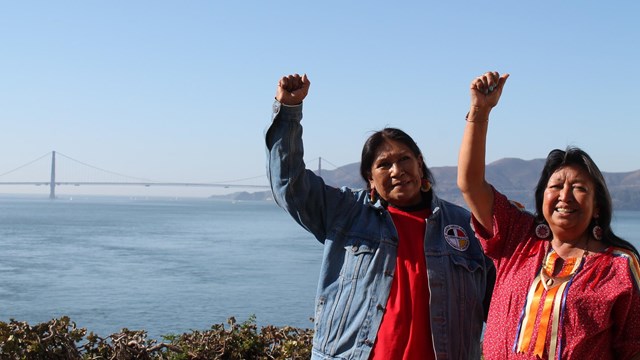 Two occupiers - Beatrice Jackson and Elaine Duncan raised fist, Golden Gate Bridge