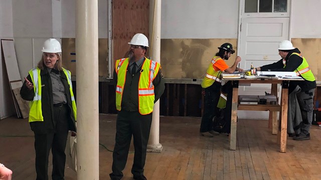 People in safety vests and hard hats inside Building 993.