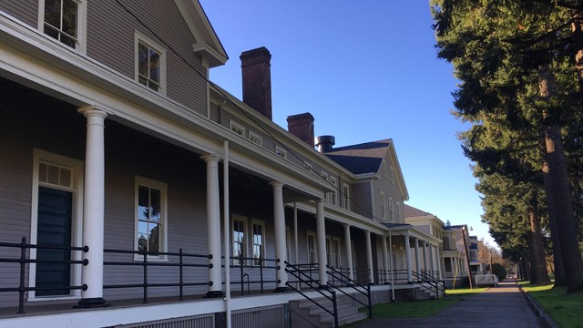 A line of barracks buildings on a sunny day.