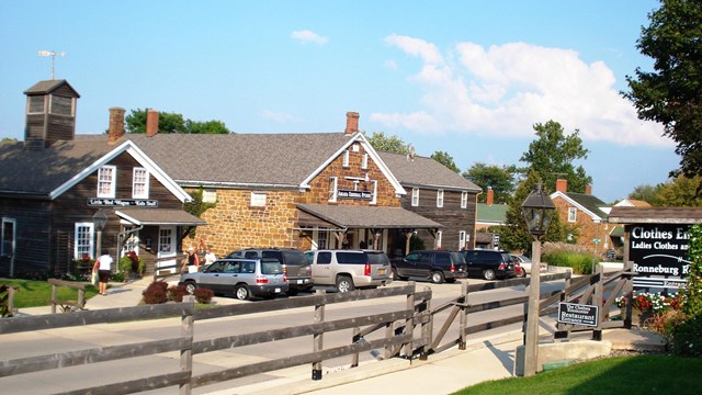 Historic houses by wooden fence. Public domain. 