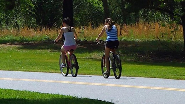 Two visitors ride bikes on the loop 