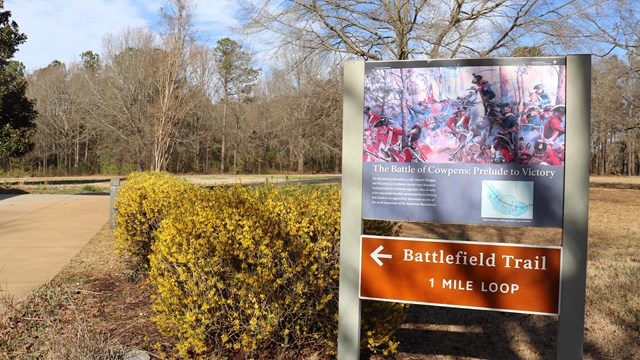 Sign for Battlefield Trail pointing the direction of the trail. 