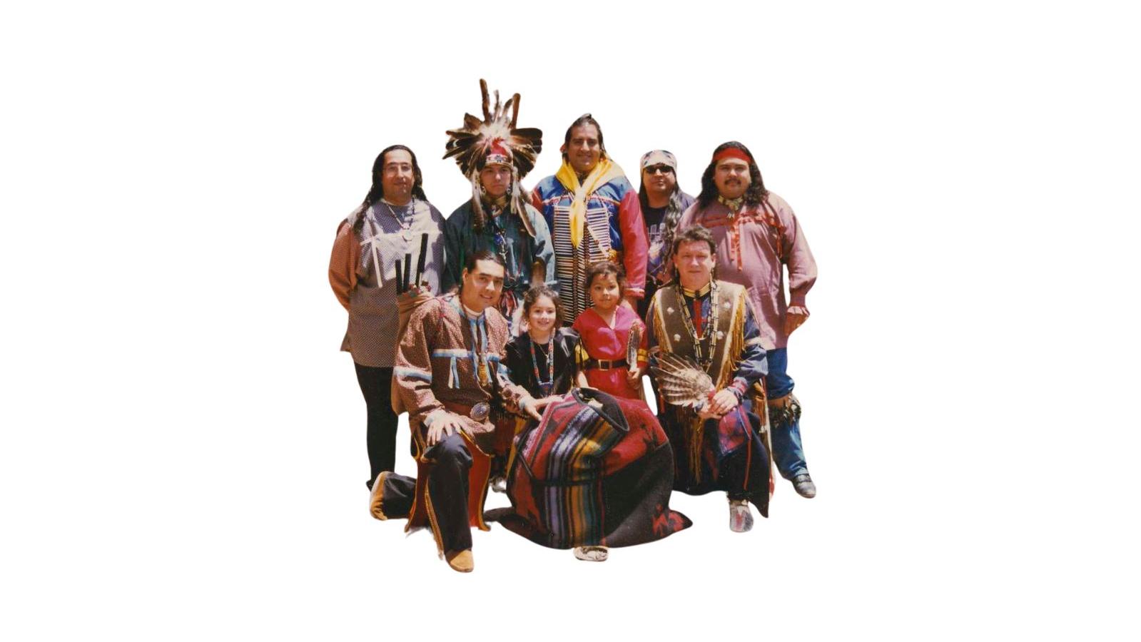 Native American family posing in front of a historic structure