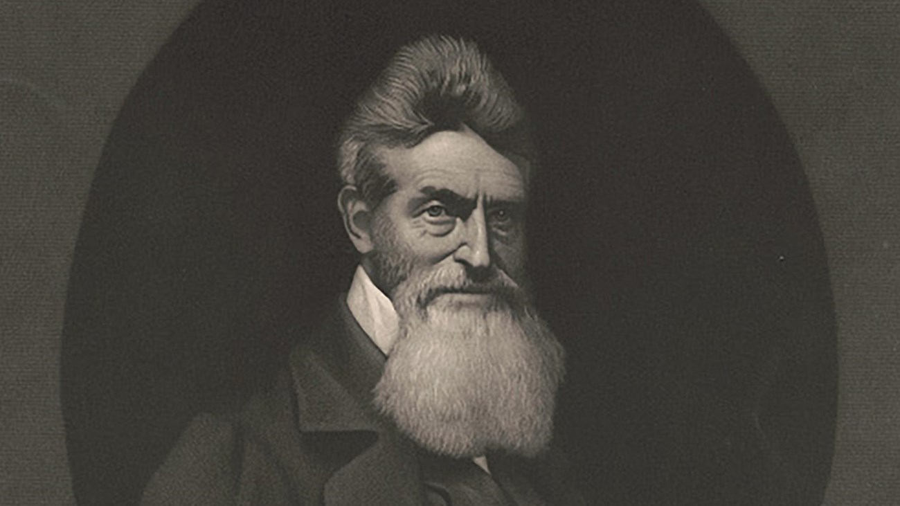 John Brown stares into the camera as his beard cascades over his chest.