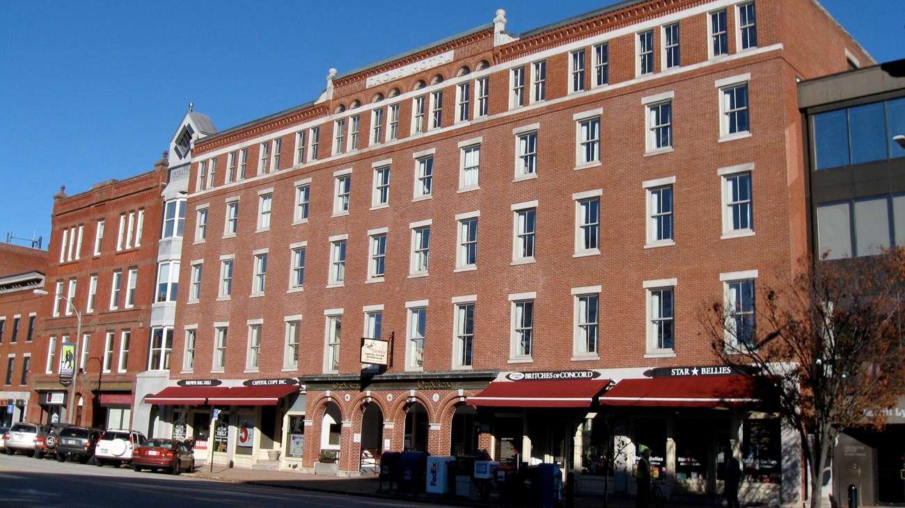 Exterior of long brick buidlign with windows. Photo: by Ken Gallager, CC BY-SA 3.0, 