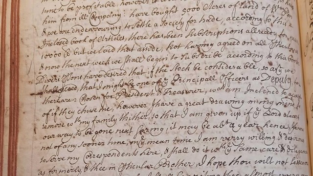 black inked handwriting on yellowed book page