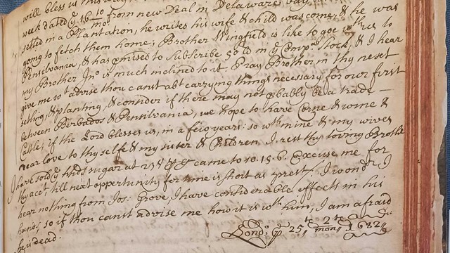 black inked handwriting on yellowed book page