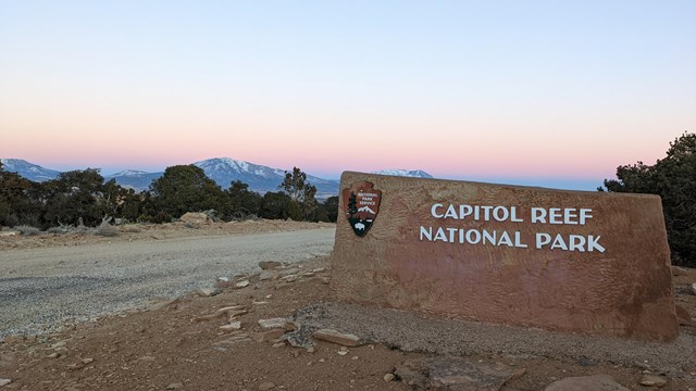 Capitol Reef sign with mountain in the background