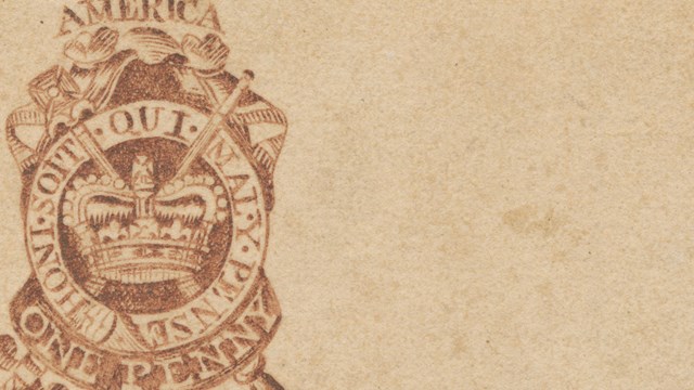 a piece of parchment and a stamp that says one penny