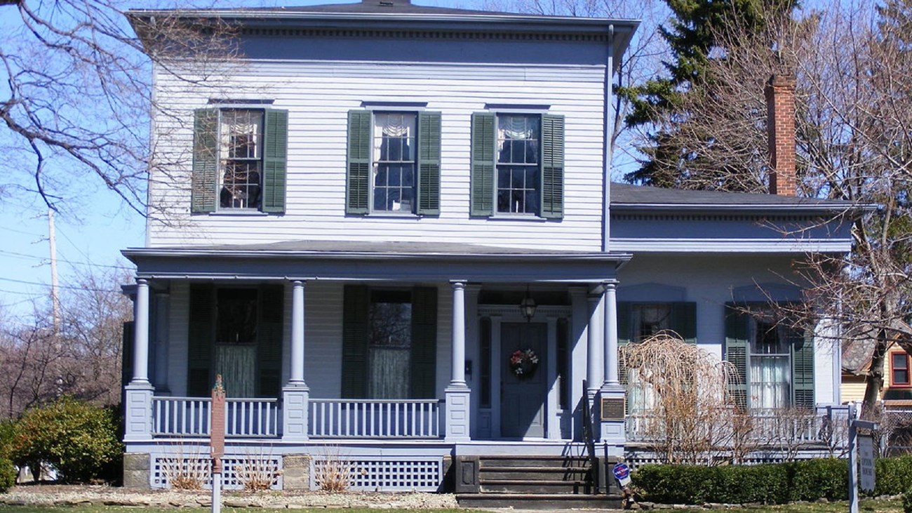 Image of the exterior of two-story Upton house. Public Domain 