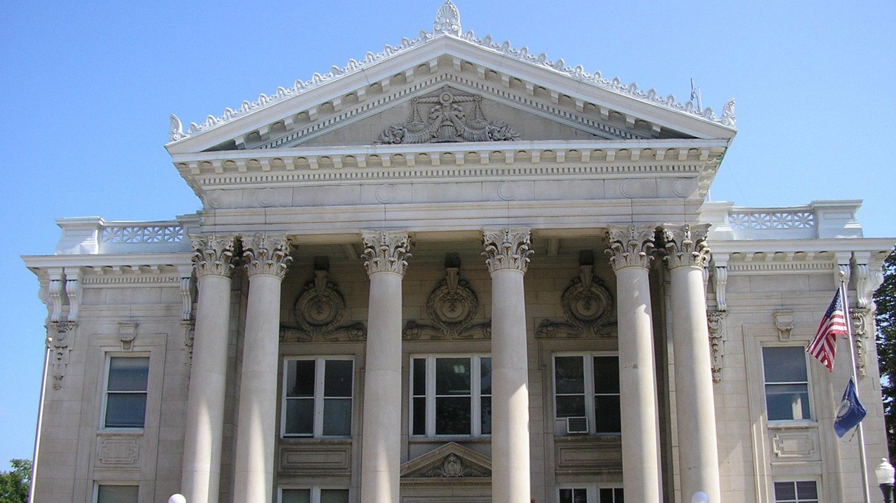 Stone courthouse with Greco-Roman columns. 