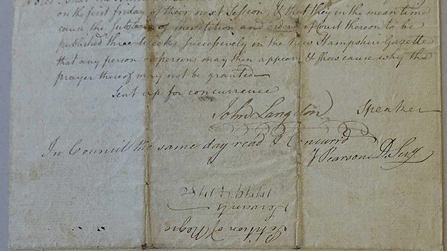 A yellowed, folded page half-filled with cursive writing, ending with signatures.