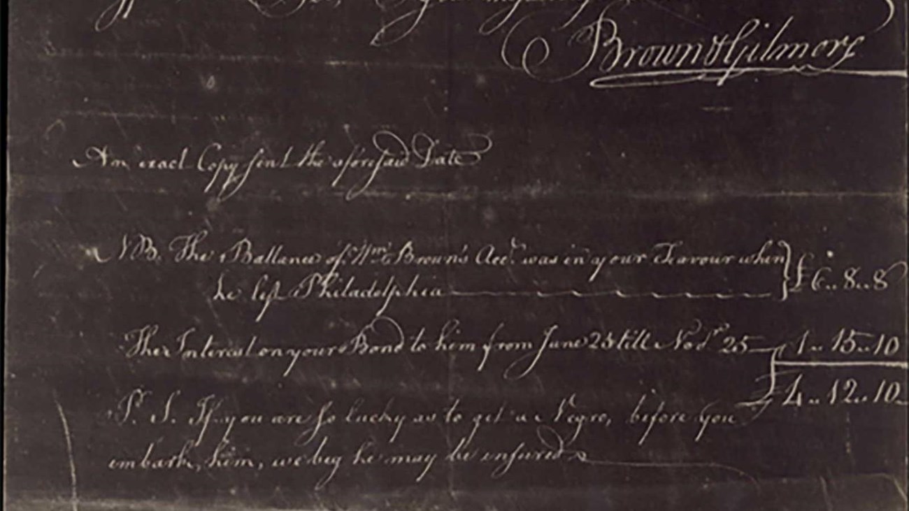 Handwritten white text on grey paper.