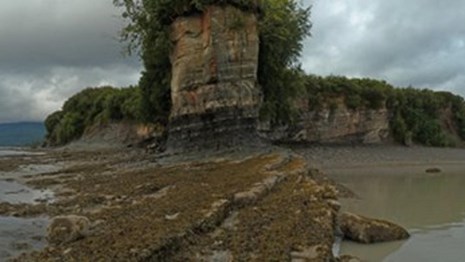 A panorama view of a coastline and cliff
