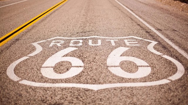Image of Route 66 sign next to restaurant. 