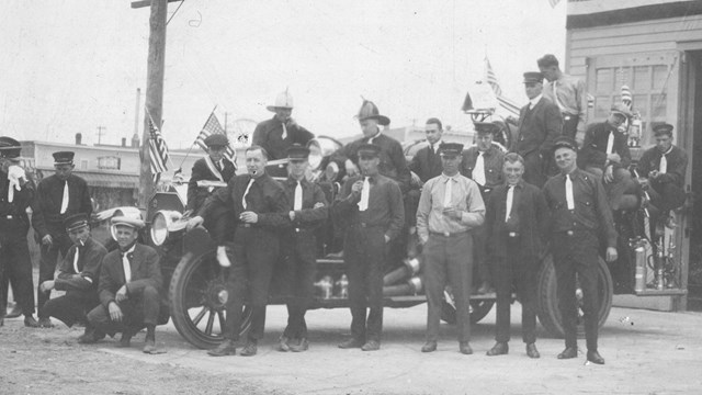 Black and white photo showing Thomas Bevers and a large group of men from his Fire Department Crew, 