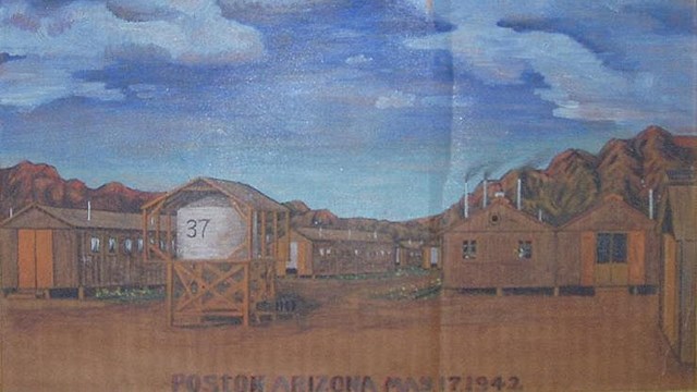 Color painting of military barracks set on a deserted landscape with rocky mountains looming behind.