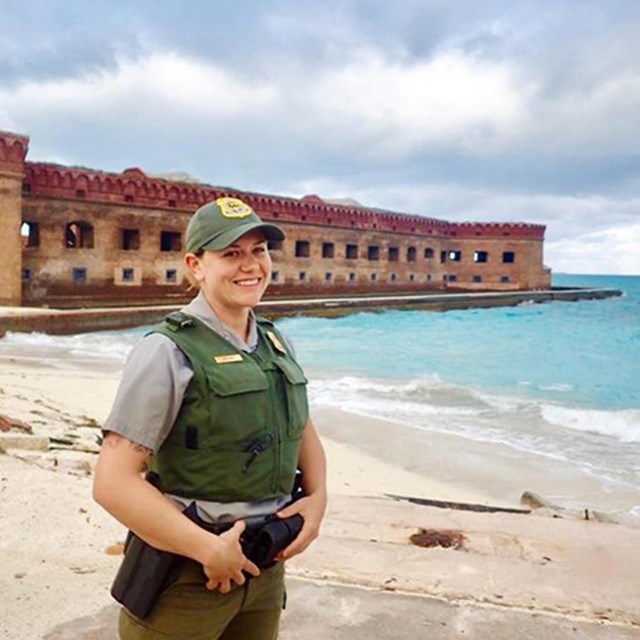 Erin Rust stands in front of the fort on the beach at Dry Tortugas.