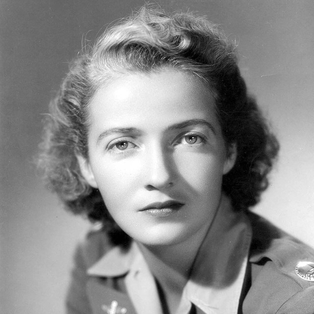 Portrait photo of white woman in military uniform.