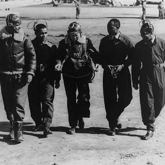 a group of people standing in front of a field