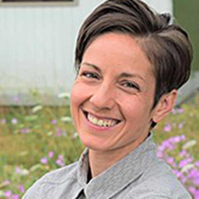 Portrait of Christina Aiello against a background of wildflowers