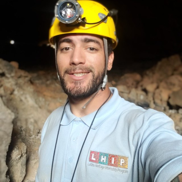 LHIP intern wearing a helmet in a cave