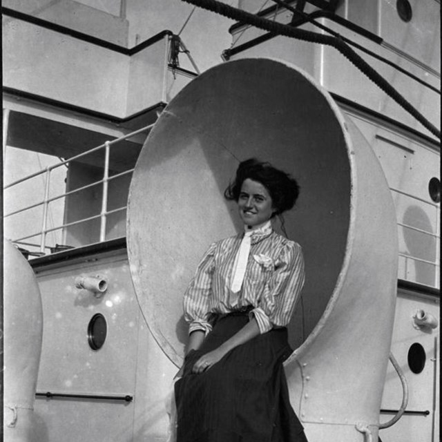 Rose Kennedy sits on the rim of a large air vent on a steamer. 