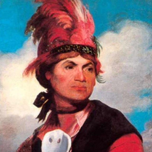 Painting of American Indian in traditional garb. 