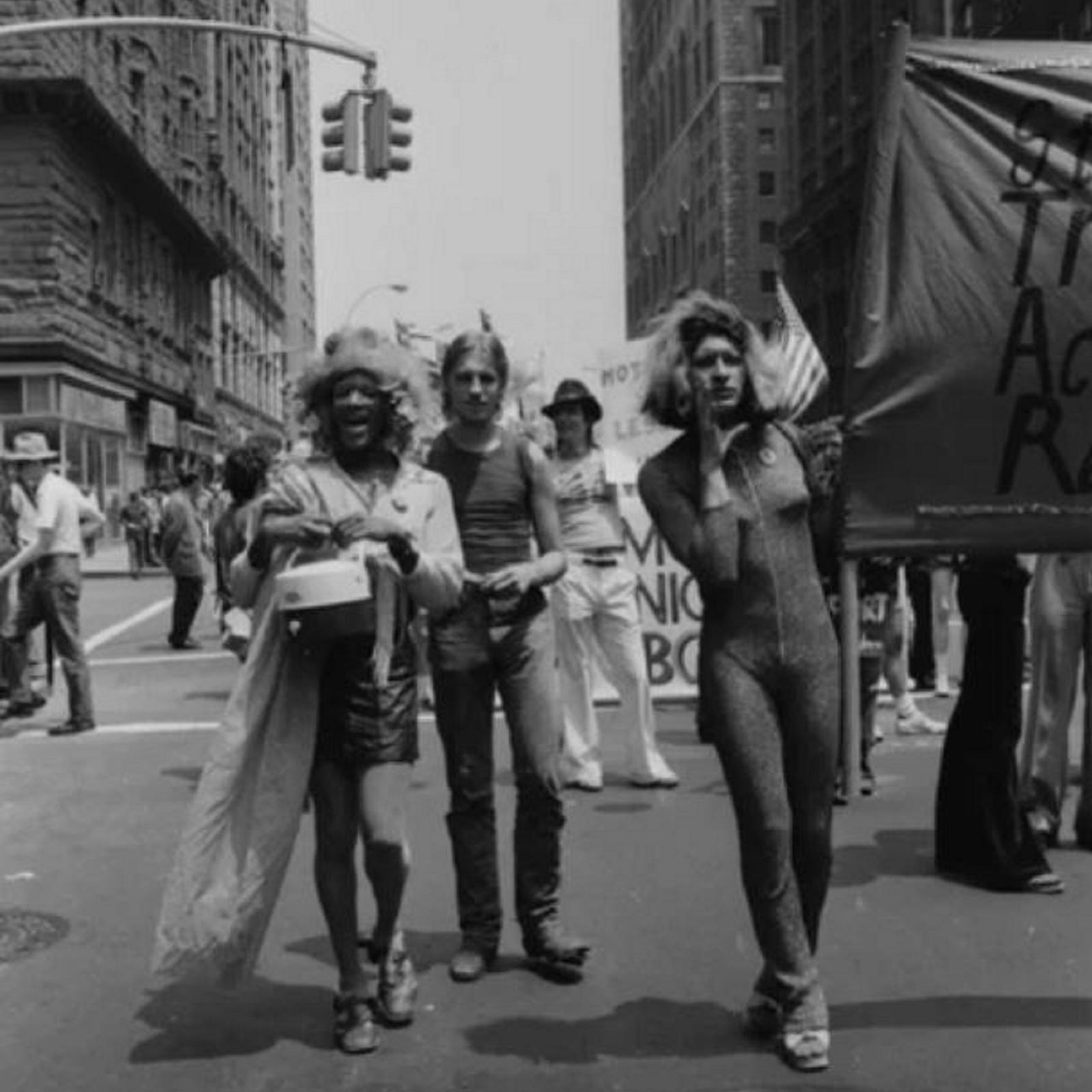 People march through the streets holding a banner