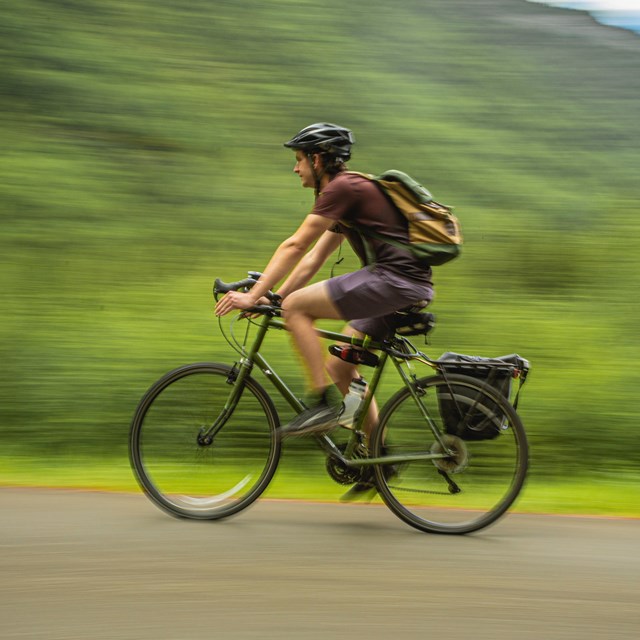 A person in a helmet rides a bicycle