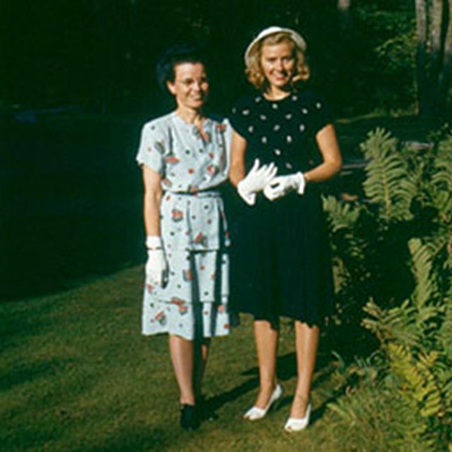 Ardra on the left stands next to a tree with her friend Sylvia Cough