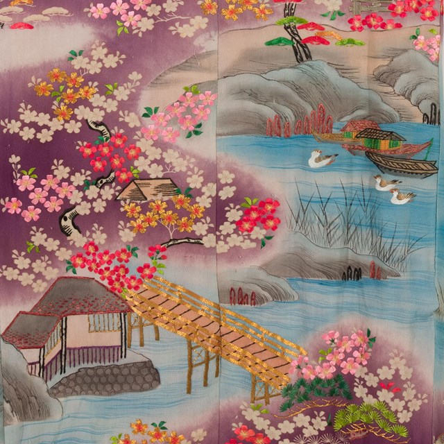 Detail of embroidered silk kimono with landscape scene