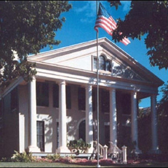 Large building with flag pole. 