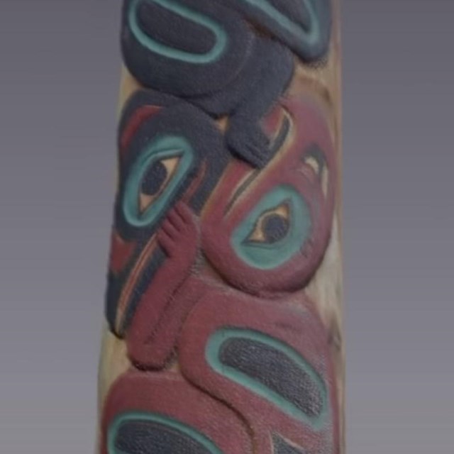 Point-cloud render of totem pole carved with raven and eagle