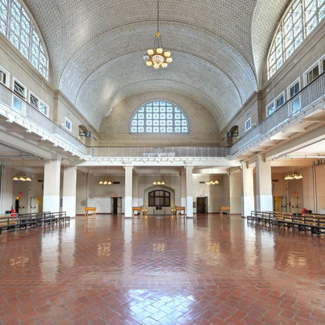 Photograph of two-story hall with vaulted ceiling and large windows