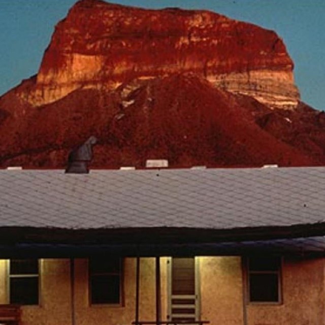 Photo of mountain with a building in foreground. 