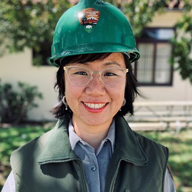 Portrait of Ming-Yi wearing a hard hat standing outside