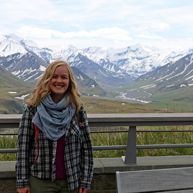 Lindsey stands in front of a mountain range