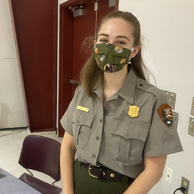 A park ranger wearing a face mask.