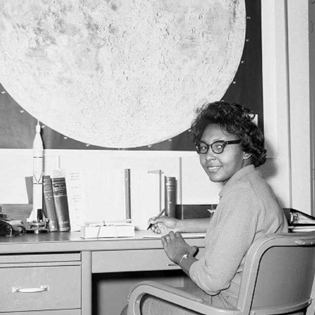 Photo of woman at a desk. 