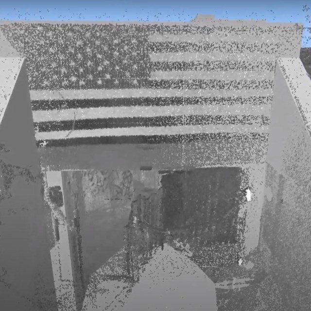 3-D rendering of concrete bunker entrance with American flag graffiti