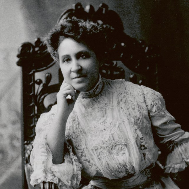 Studio portrait of Mary Church Terrell seated leaning on her right hand propped on chair armrest