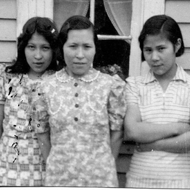 Left side, three dark haired women standing together; right side two people in front of a sign