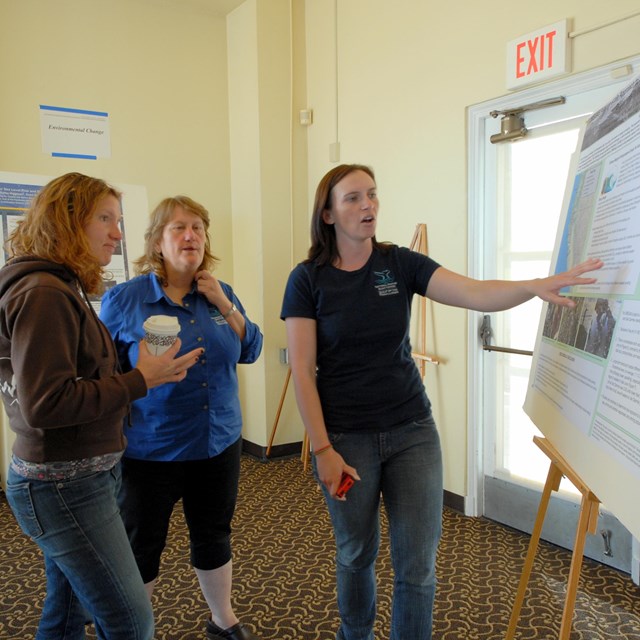 People discussing a park science poster
