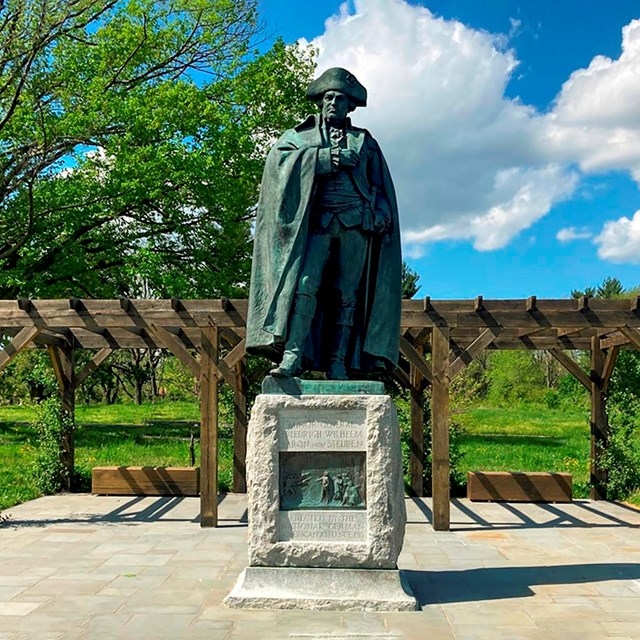 State of a soldier wearing a cloak and a tricorn hat