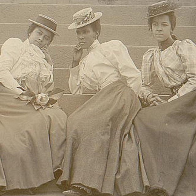 Black women sitting on stairs