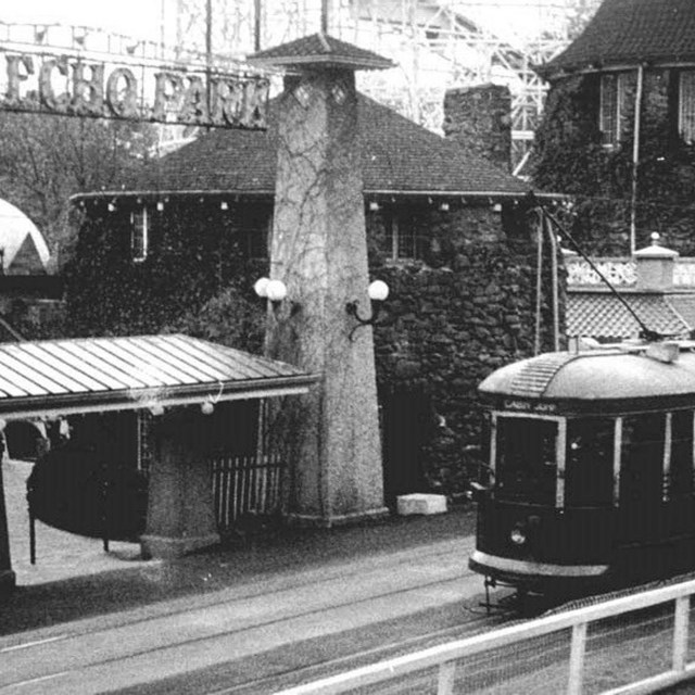 A streetcar outside an amusement park entrance