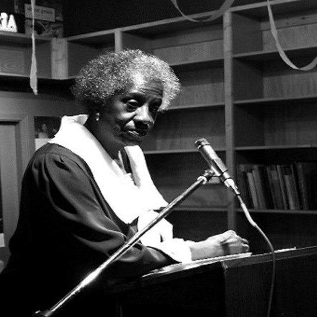 Woman standing at a podium speaking